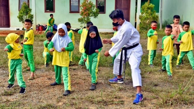 
					Seorang prajurit Marinir tengah melatih siswa-siswi Madrasah Ibtida'iyah (MI) Darul Quran di Sebatik (perbatasan Malaysia). (SWARAJOMBANG.com/ Disoen Kormar)
