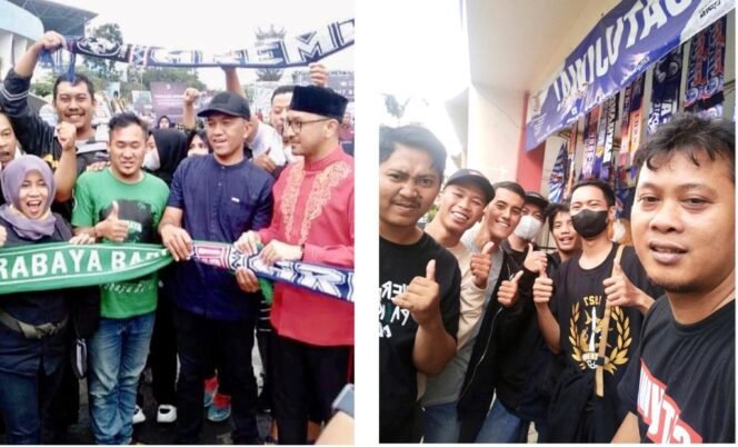 
					Dua kubu suporter yang menjadi musuh bebuyutan, Aremania (Arema FC) dan Bajul Ijo (Persebaya) telah bersatu dan berangkulan. Fanatisme tidak harus saling pukul, tapi harus saling rangkul. (Foto: SWARAJOMBANG.com/Anwar Hudijono)