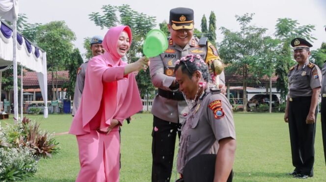 
					Kapolres beserta Ketua Bhayangkari Polres Jombang saat lakukan prosesi siraman kembang kepada salah satu personel yang naik pangkatnya