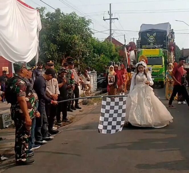 
					Kepala desa Sidowarek Drs Fatchurrohman bersama forkopimca Ngoro, kibarkan berdera start karnaval bersih desa, diikuti 13 tim dari 7 dusun plus 6 tim sound horek dari titik start dusun Winorejo. Foto: swarajombang.com/ sri muryanto